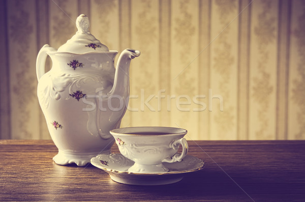 ld-fashioned vintage jug with tea with wallpaper background Stock photo © dla4