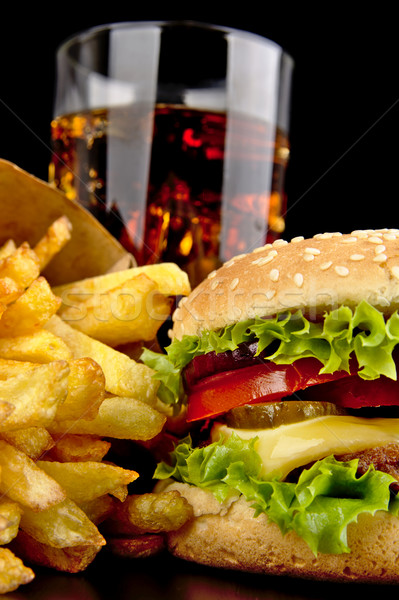 Menu of cheeseburger,french fries,glass of cola on black Stock photo © dla4