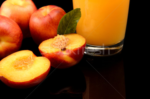 Stock photo: Close-up shot sliced orange nectarines with juice and leaf