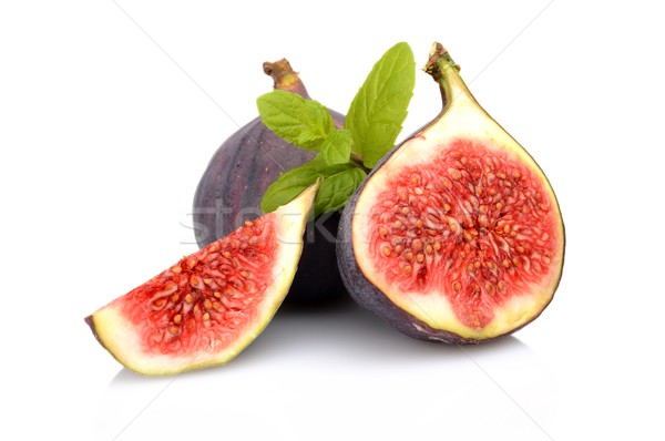 Three sliced figs with mint isolated on white background Stock photo © dla4