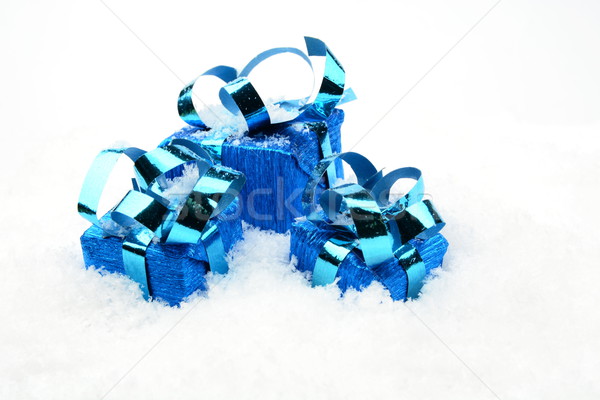 Stock photo: Three blue christmas gifts on snow