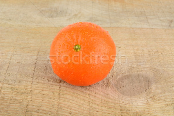 Studio shot wet tangerine isolated on wooden table Stock photo © dla4