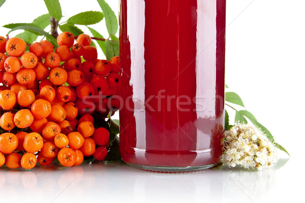 Cropped orange ash-berry with jar of juice on white Stock photo © dla4