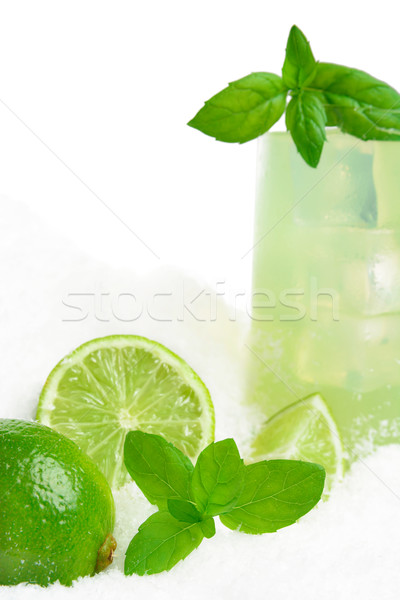 Cropped image-glass of lime juice with ice cubes on snow on white Stock photo © dla4