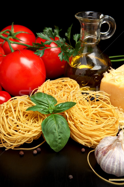 Round balls of pasta with cheese, tomatoes,basil,olive oil on black Stock photo © dla4