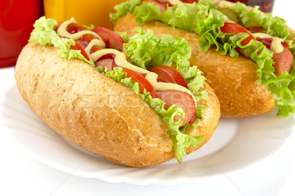 Hotdogs on plate with cola on white background Stock photo © dla4