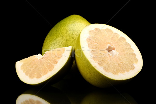 Three pomelos,half,quarter isolated on black Stock photo © dla4
