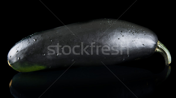 Black wet courgette on black background Stock photo © dla4