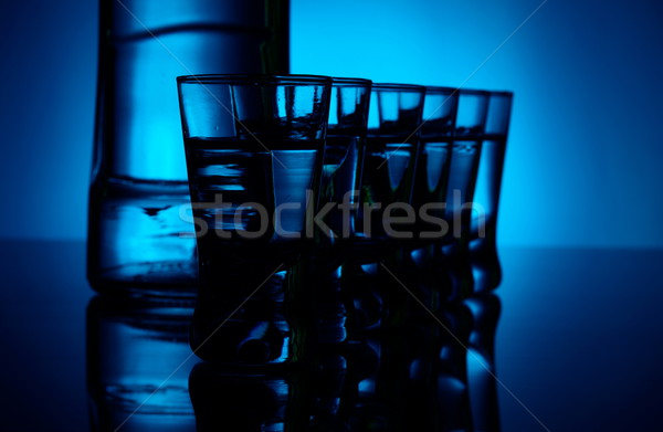Butelki wódki wiele okulary niebieski podświetlenie Zdjęcia stock © dla4