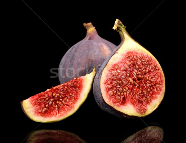 Three sliced figs isolated on black background Stock photo © dla4