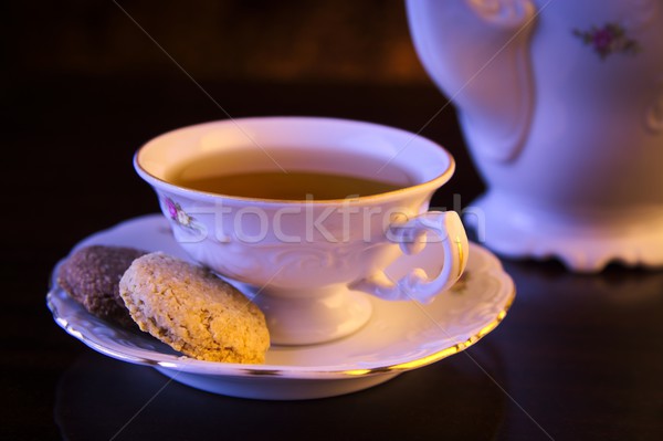 Old-style kettle with cup of tea on black Stock photo © dla4
