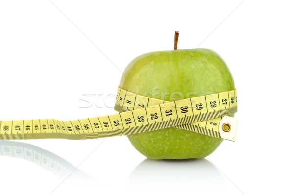 Stock photo: Studio shot of whole green healthy apple with tape measure