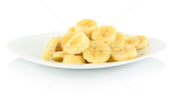 Stock photo: Macro shot of slices of banana on plate on white 