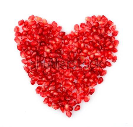 Red heart made from seeds of pomegranate,grenadine on white Stock photo © dla4