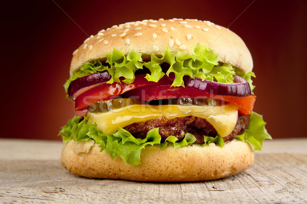 Big cheeseburger isolated on red background Stock photo © dla4