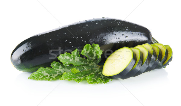 Courgettes cut into slices and leaves on white Stock photo © dla4