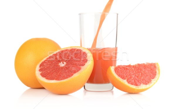 Studio shot sliced grapefruits with poured juice on white Stock photo © dla4