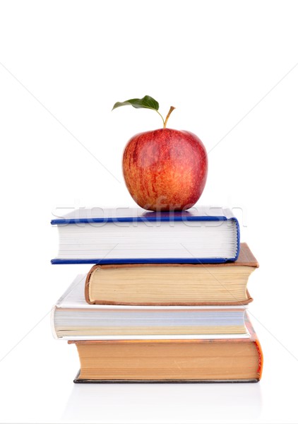 Stock photo: Apple on few school books isolated on a white background