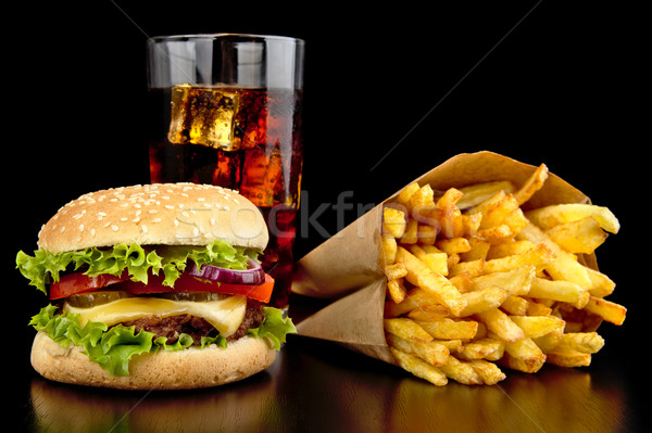 Big cheeseburger with glass of cola and french fries on black de Stock photo © dla4