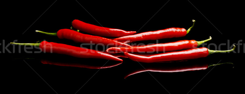 Perspective view of red peppers isolated black background Stock photo © dla4