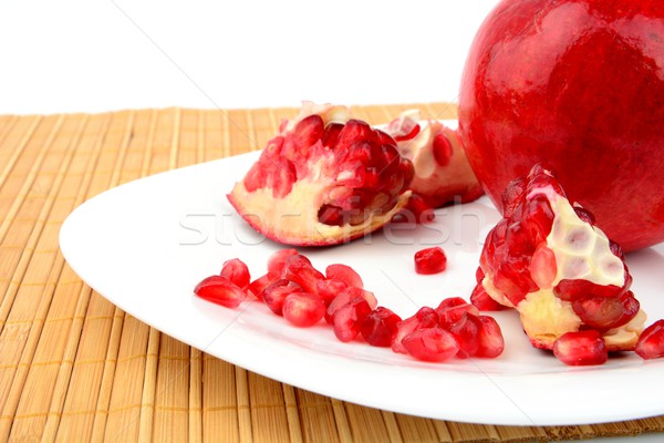 Studio shot open pomegranate on plate wooden mate Stock photo © dla4