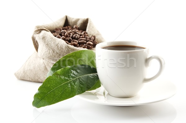 Sack full of coffee beans with green leaves and coffee cup Stock photo © dla4