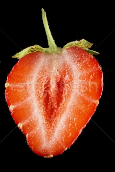 Macro view of half of strawberry isolated on black Stock photo © dla4