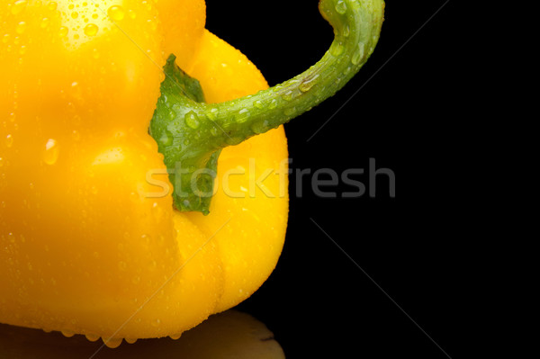 Cut shot of yellow bell pepper isolated on black with water drop Stock photo © dla4