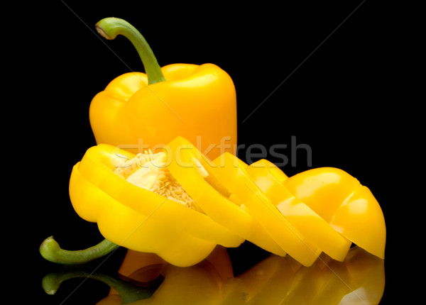 Closeup slices of yellow bell peppers isolated on black Stock photo © dla4