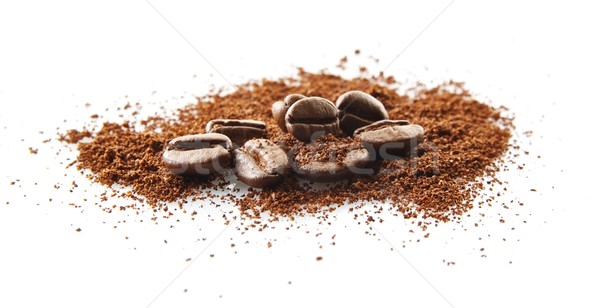 Collected coffee beans with coffee powder on white Stock photo © dla4