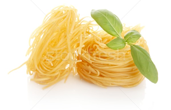 Closeup shot of tagliatelle with basil isolated on white Stock photo © dla4