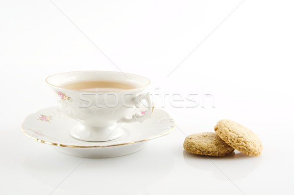 Old-style vintage cup of tea with cookies on white background Stock photo © dla4