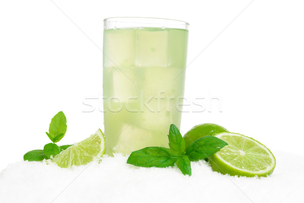 Glass of lime juice with ice cubes on snow on white Stock photo © dla4