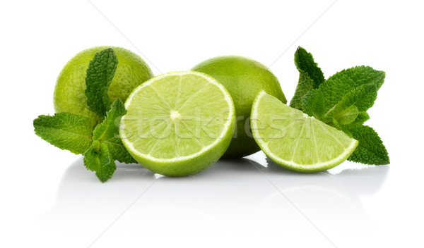 Three sliced limes with mint isolated on a white background Stock photo © dla4