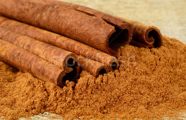 Closeup shot of cinnamon on cinnamon powder on wooden table Stock photo © dla4