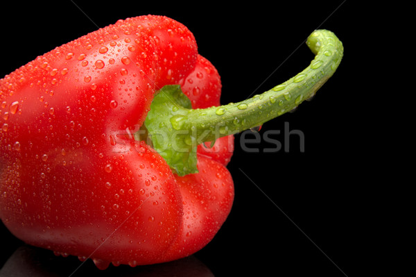 Studio shot of red bell pepper isolated on black with water drop Stock photo © dla4