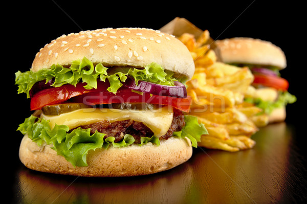 Big cheeseburgers with french fries on black board Stock photo © dla4