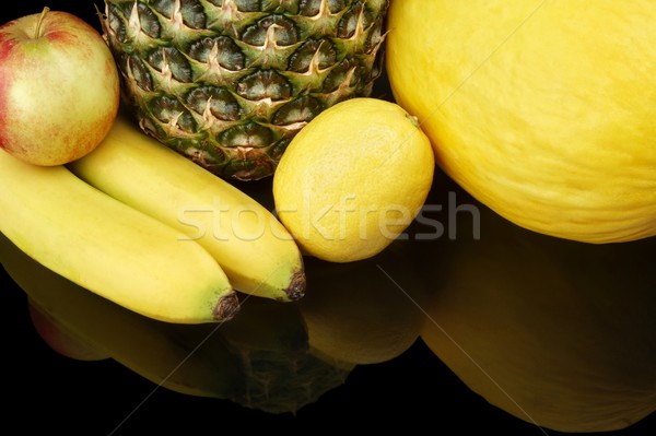 Set of yellow fruits-pineapple,citrus,bananas on black at the bottom Stock photo © dla4