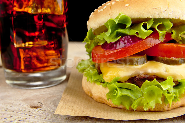 Big cheeseburger with glass of cola on wooden table Stock photo © dla4