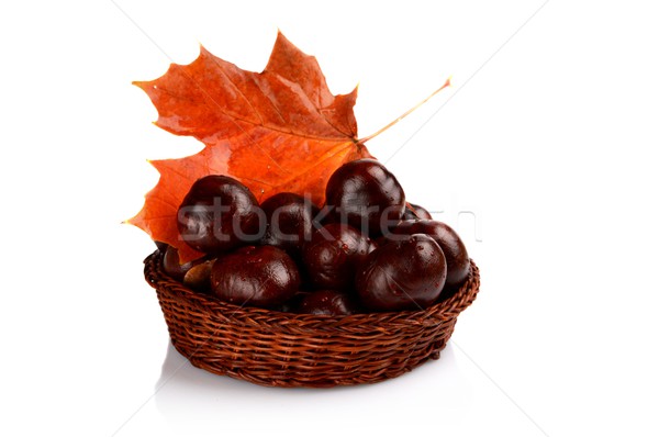 Closeup basket with chestnuts and leaf isolated on white Stock photo © dla4