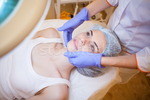 doctor cosmetologist doing facial massage girl spa Stock photo © dmitriisimakov