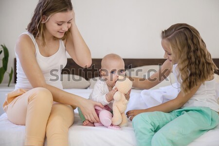 Stock photo: three girls sisters woke up in the morning in the bedroom on the bed