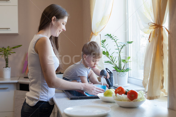 kitchen mom son wash fruits and vegetables Stock photo © dmitriisimakov