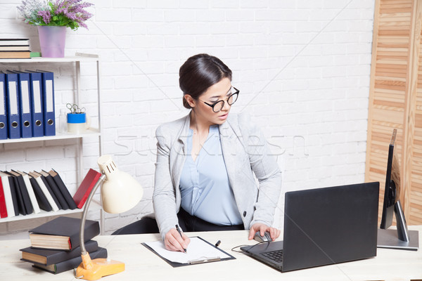 Stock photo: business woman in an Office works at the computer