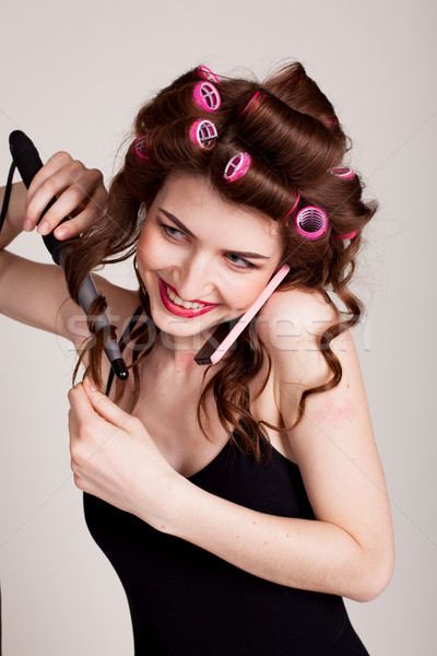 girl with hair curlers talking on the phone and makes the hairstyle Stock photo © dmitriisimakov