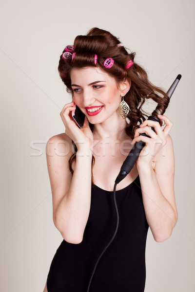 girl with hair curlers talking on the phone and makes the hairstyle Stock photo © dmitriisimakov