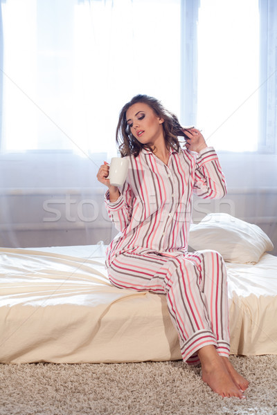 girl in pajamas woke up in the morning and drink coffee or tea Stock photo © dmitriisimakov