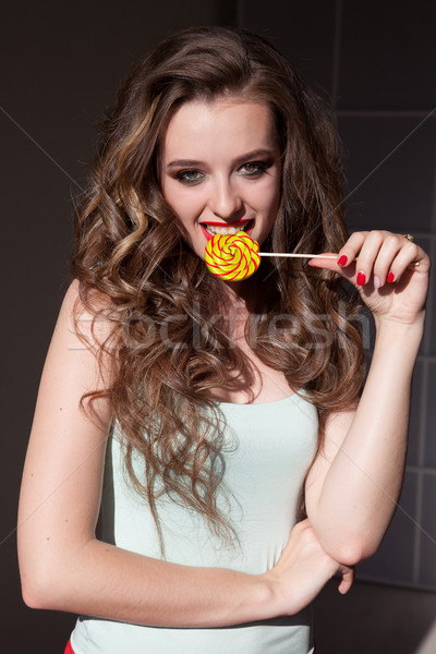 girl in colorful clothes eats colored lollipop tasty Stock photo © dmitriisimakov