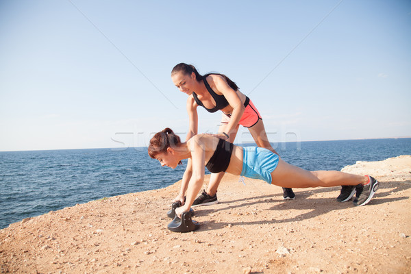 fitness instructor teaches a woman to play sports Stock photo © dmitriisimakov