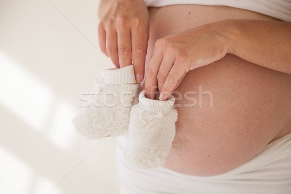 the stomach of a pregnant woman and baby stuff socks 1 Stock photo © dmitriisimakov
